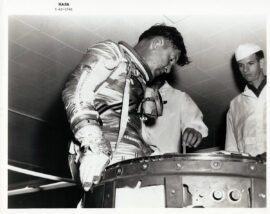ASTRONAUT WALTER M. SCHIRRA JR. PRACTICES EGRESS FROM SPACECRAFT (1962) Official NASA publicity photo