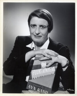 AYN RAND POSES WITH AN EDITION OF THE FOUNTAINHEAD (1949) Publicity photo