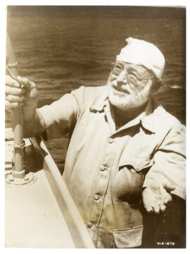 ERNEST HEMINGWAY FISHING (1958) Studio publicity portrait